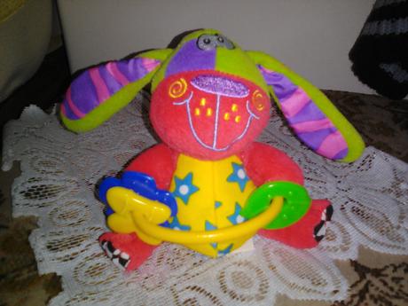 Plyšový pejsek v pestrých barvách,