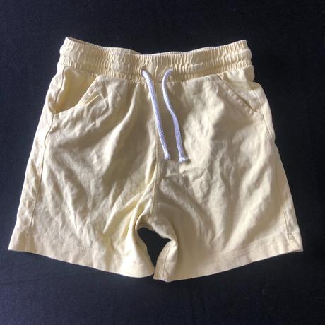 Vel. 116 žluté tenké šortky s kapsami a tkanicí, 116